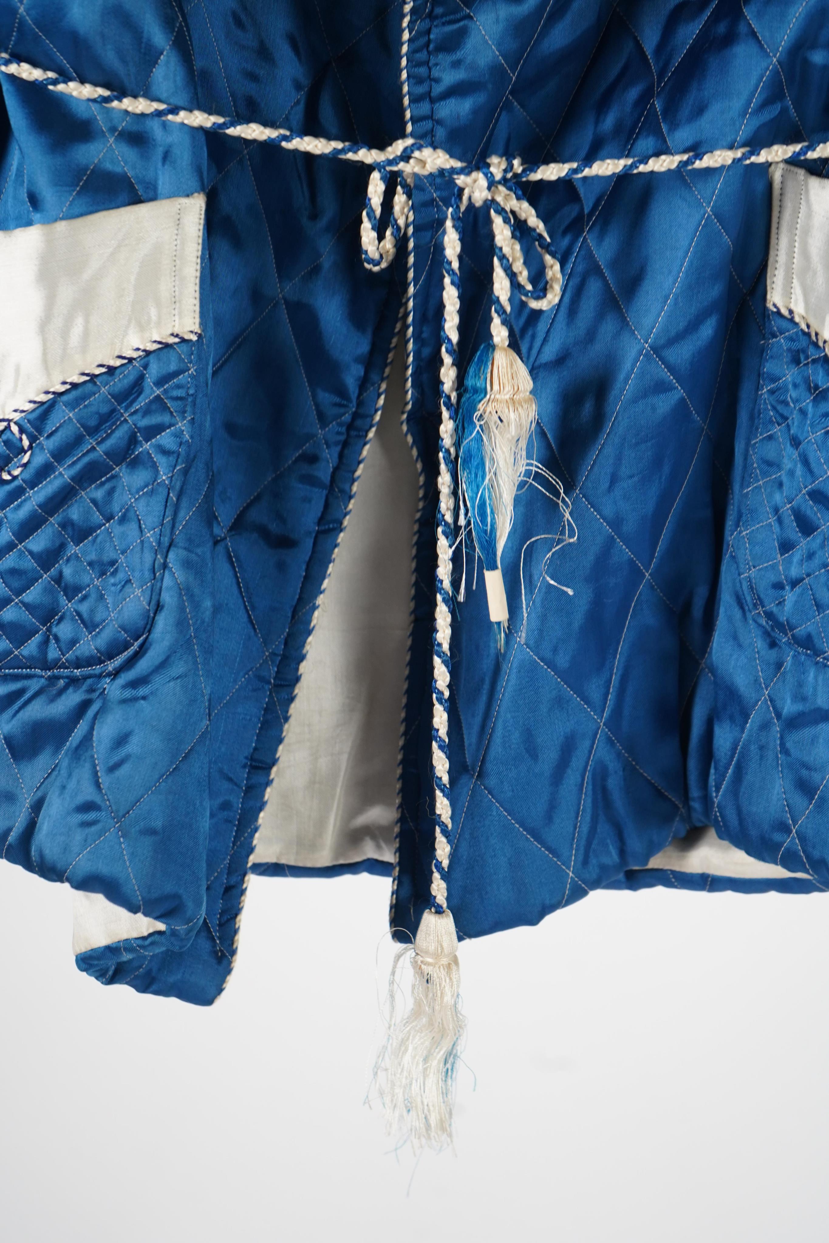 A mid 20th century Royal blue satin gentleman’s smoking jacket and matching dressing gown with Chinese gold dragon embroidery to both the quilted collars and cuffs, measurement from top back of collar to bottom of dressi